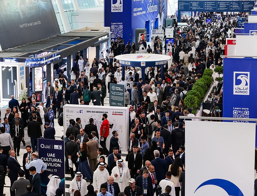 Alt text: Busy international trade show floor with crowded exhibition booths, branded displays, and professionals networking inside a large convention hall.